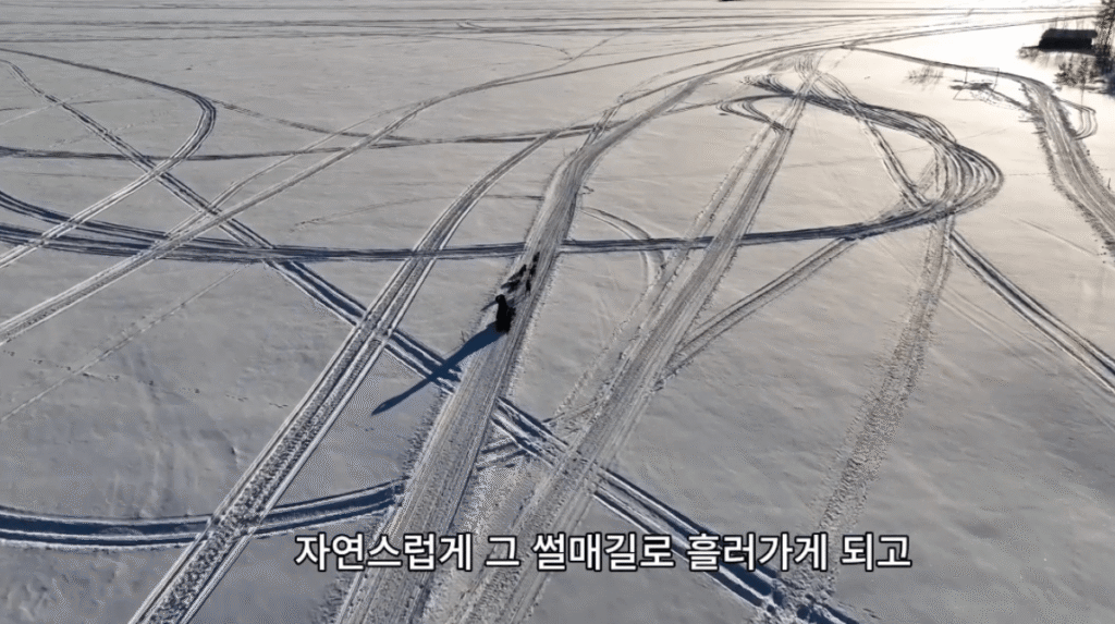 자연스럽게 그 썰매길로 흘러가게 되고, 흰 눈 배경에 썰매길이 여러 군데로 그려져 있습니다.